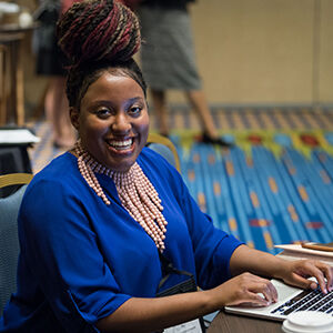 Woman typing at the Biennial Conference
