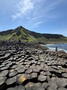 A close-up shot of the tightly packed, interlocking hexagonal stones of the Giant's Causeway, showcasing the uniform, crack-like patterns of the ancient volcanic rock.