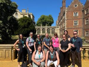 Group of NAFAns posing in front of the Bridge of Sighs in Cambridge, with the river and historic college architecture behind them.