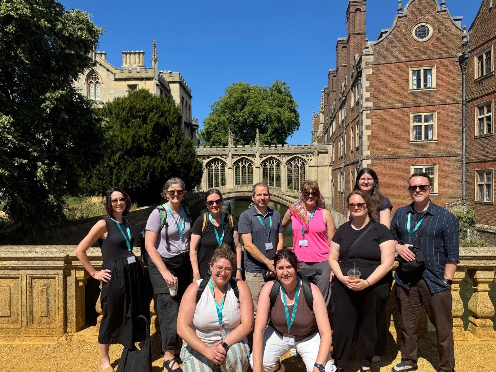 Group of NAFAns posing in front of the Bridge of Sighs in Cambridge, with the river and historic college architecture behind them.