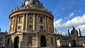 Circular, Baroque-style Radcliffe Camera at the University of Oxford, featuring a stone facade and grand domed roof.